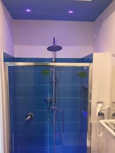 a bathroom with a shower with a blue wall at CIVICO 29 in Pompei +94 photos