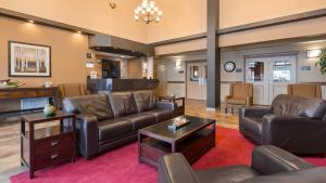 a living room with a couch and a table at Best Western Plus Kamloops Hotel in Kamloops