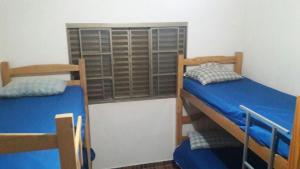 a bedroom with two bunk beds and a window at Casa para temporada da Vó Cida in Olímpia
