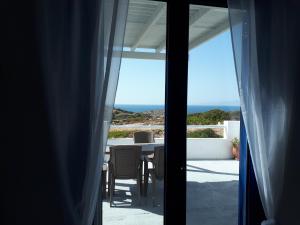a room with a table and a view of the ocean at Sunset in Irakleia