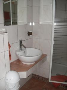 a bathroom with a sink and a toilet at Hotel Cappuccino in Elze