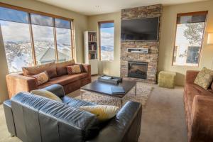 a living room with couches and a fireplace at Absollut in Mount Hotham
