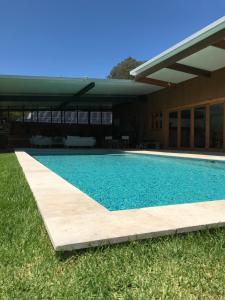 a swimming pool in front of a house at Blair Athol Estate Wollombi in Wollombi