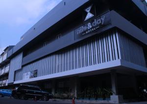 a building with a car parked in front of it at Nite & Day Surabaya - Kedungdoro in Surabaya