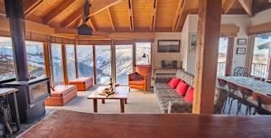 a living room with a view of the mountains at Nolyski in Mount Hotham
