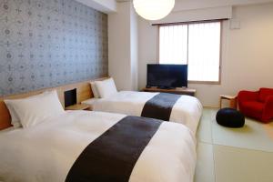 Voodi või voodid majutusasutuse Hotel M's Plus Shijo Omiya toas