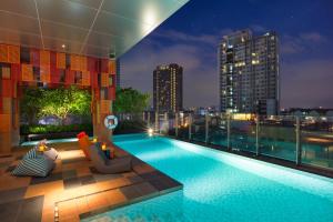 une piscine au sommet d'un immeuble avec une vue sur la ville dans l'établissement ibis Styles Bangkok Sukhumvit Phra Khanong, à Bangkok