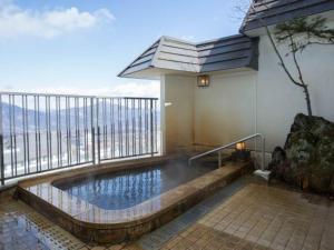 a swimming pool on the balcony of a building at Kindayu in Shibukawa
