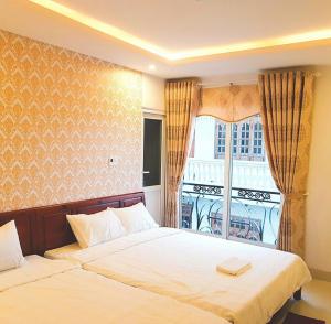 Postelja oz. postelje v sobi nastanitve Hotel Hoàng Thịnh