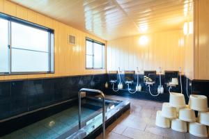 a bathroom with a tub and sinks and toilets at 高野山 宿坊 常喜院 -Koyasan Shukubo Jokiin- in Koyasan