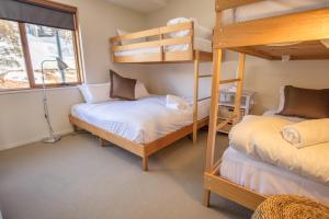 a bedroom with two bunk beds and a window at Sambuca in Mount Hotham