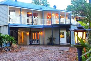 a large house with a balcony and a street light at CLOUD 9 - Cliff Top Eagle Heights in Mount Tamborine