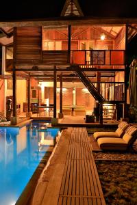 a living room with a pool and a house at Apalagi Villas in Gili Air