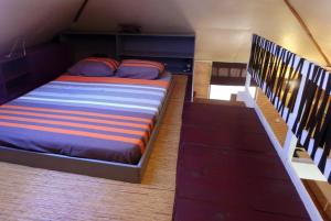 un grande letto in una stanza con scala di JUSTMOOREA Location Haapiti a Haapiti