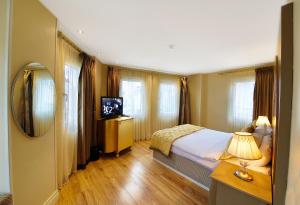 Postel nebo postele na pokoji v ubytování Katelya Hotel