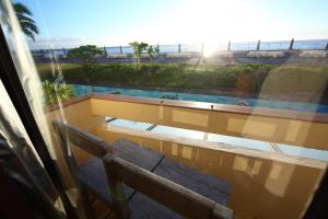 a view from a window of a bench and the sun at Slow Living Seaview B&B in Hualien City
