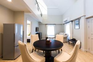 a kitchen and living room with a table and chairs at Merchant House Chiangmai in Chiang Mai