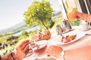 a person eating food at a table with plates of food at Stift St. Georgen am Längsee in Sankt Georgen am Längsee