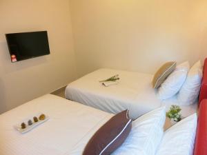 Postel nebo postele na pokoji v ubytování Carlsun Hotel