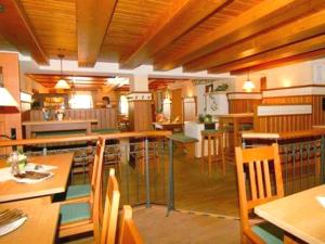 a dining room with wooden tables and chairs at Landhotel Kistlerwirt in Bad Feilnbach