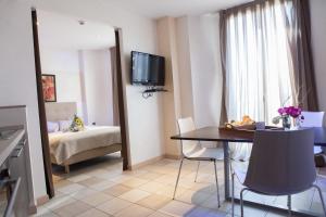 a room with a table and a room with a bed at Hotel Villa d'Elsa in Juan-les-Pins