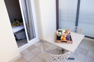 a bowl of fruit on a table on a balcony at Hotel Villa d'Elsa in Juan-les-Pins