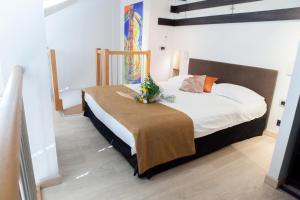 a bedroom with a bed with a blanket on it at Hotel Villa d'Elsa in Juan-les-Pins