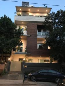 a black car parked in front of a building at Bed n Oats in Gurgaon