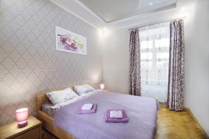 a bedroom with a bed with two towels on it at Premium Hostel in Lviv