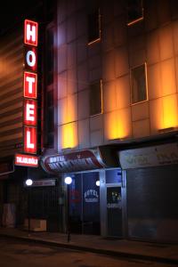 a building with a neon sign in front of it at Talaslioglu Hotel in Kayseri