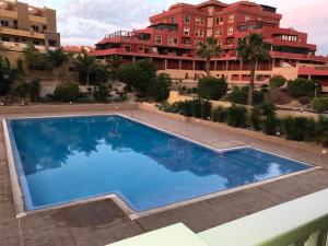 a swimming pool on the roof of a building at La Perla Medano 2 in El Médano