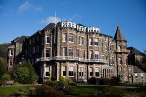 a large brick building with a lot of windows at Keswick Country House Hotel in Keswick