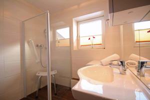 a bathroom with a sink and a glass shower at Almliesl ZELL-448 in Zell am See +12 photos