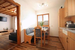 a kitchen and dining room with a table and chairs at Almliesl ZELL-448 in Zell am See