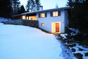 a house in the snow with its door open at Adele (704 De) in Lenzerheide