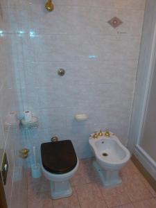 a bathroom with a toilet and a sink at B&B Villa Giovanni in Casal Palocco