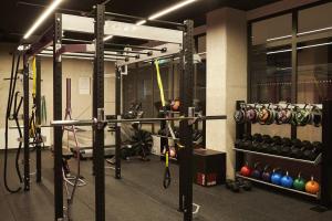 a gym with a lot of equipment in it at Steel House Copenhagen in Copenhagen