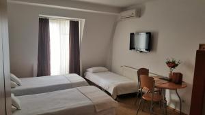 Ένα ή περισσότερα κρεβάτια σε δωμάτιο στο Hotel Topcider