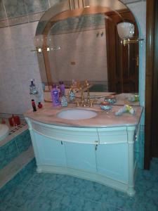 a bathroom with a sink and a mirror at B&B Villa Giovanni in Casal Palocco