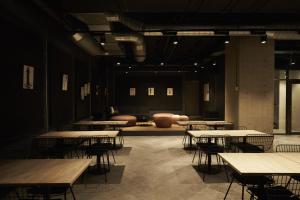 a room with tables and chairs in a building at Steel House Copenhagen in Copenhagen +37 photos