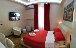 a bedroom with a red and white bed and a window at Luxury Rome Savini Guest House in Rome