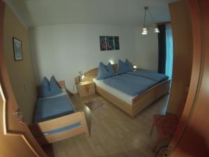 a small bedroom with a bed and a chair at Appartement Millennium in Bad Gastein