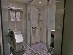 a bathroom with a toilet and a glass shower at 泊居旅店二館 Oursinn Hotel 2 in Taipei