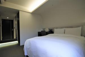 Postel nebo postele na pokoji v ubytování 泊居旅店二館 Oursinn Hotel 2