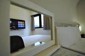 Postel nebo postele na pokoji v ubytování 泊居旅店二館 Oursinn Hotel 2