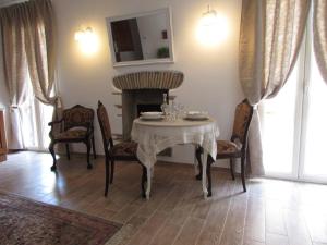 a dining room with a table and chairs and a fireplace at Casa Micheli in Centro ex Frattina Luxury Apartment in Rome