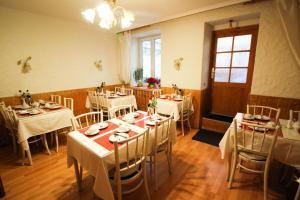 a room with tables and chairs with white tablecloths at Hotel Atlanta in Munich