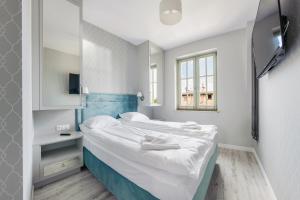 Ліжко або ліжка в номері Apartamenty Sun & Snow Na Monte Cassino