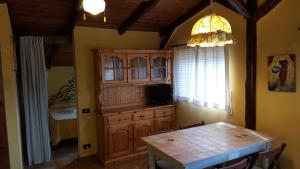 a dining room with a table and a chandelier at La Maison Galu' in Itri