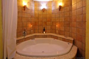 bañera grande en el baño con 2 luces en נופש דביר - צימרים מהממים למשפחות עם ג'קוזי ובריכה ליד הכנרת, en Migdal